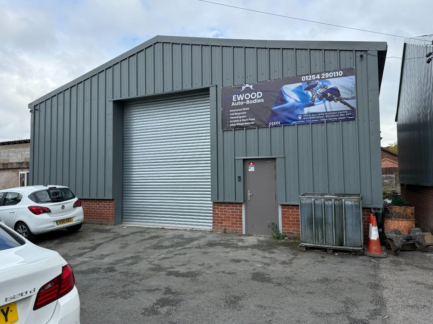 Ewood Autobodies Blackburn workshop frontage with the business sign and roller shutter